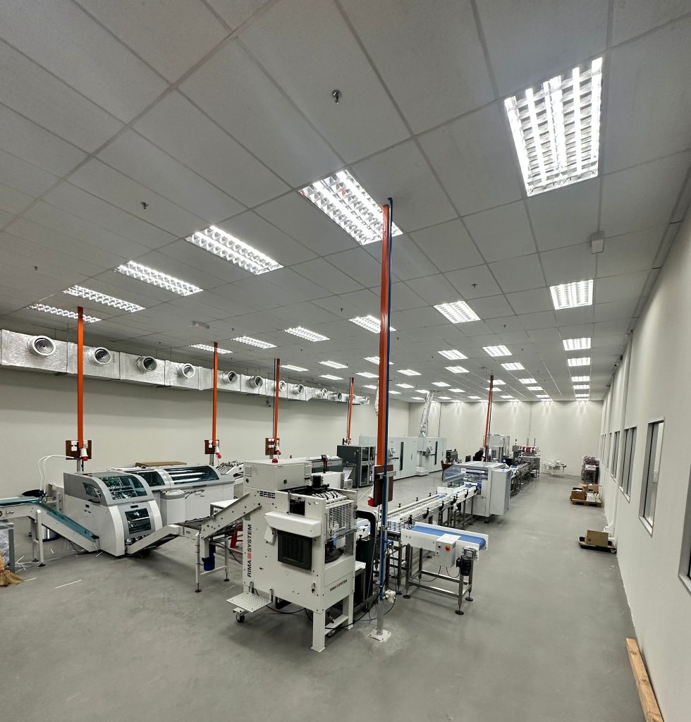 High-capacity mailroom machinery setup with automated sorting and sealing systems for efficient mail processing in large-scale mailroom operations.
