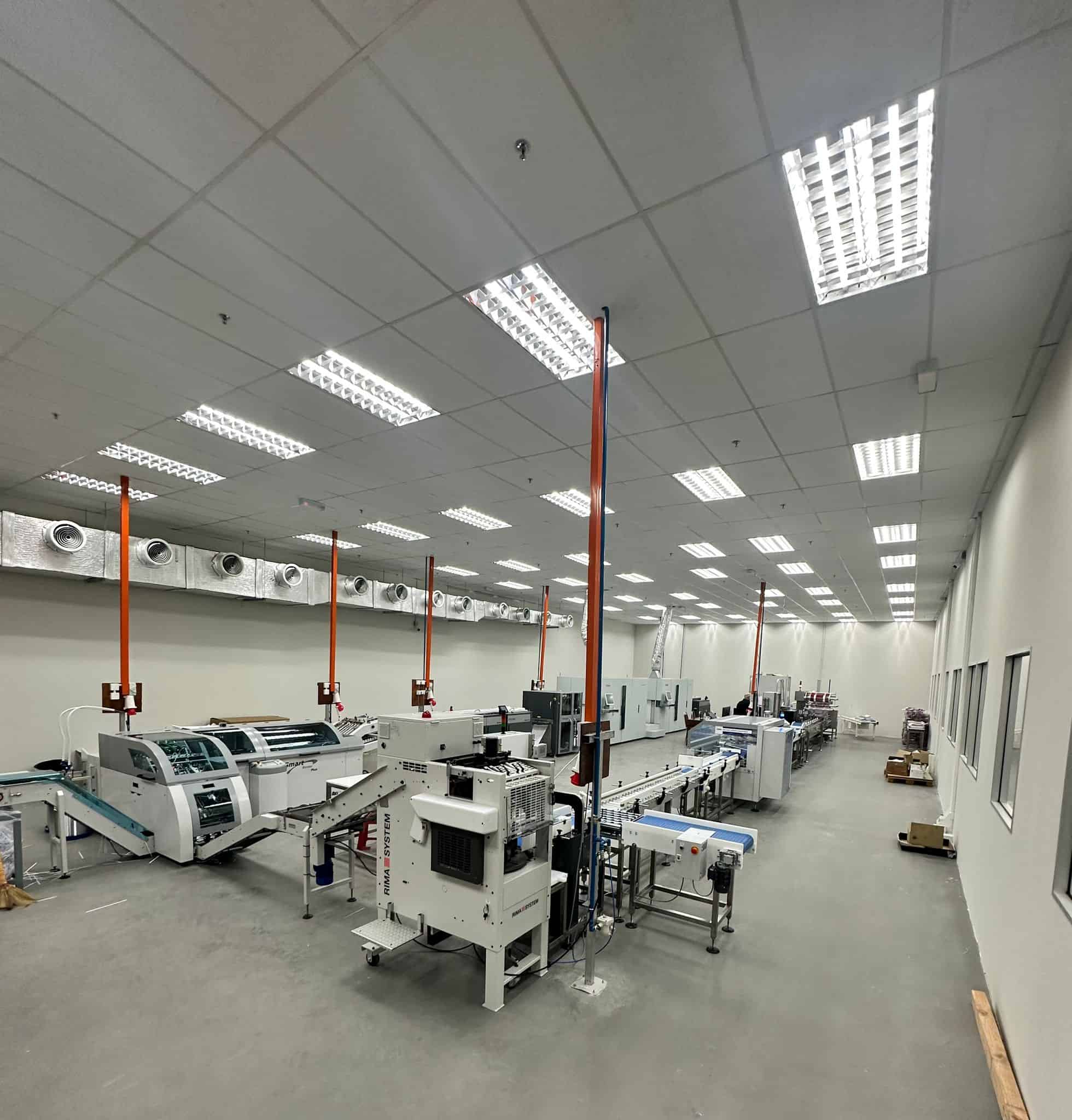 High-capacity mailroom machinery setup with automated sorting and sealing systems for efficient mail processing in large-scale mailroom operations.